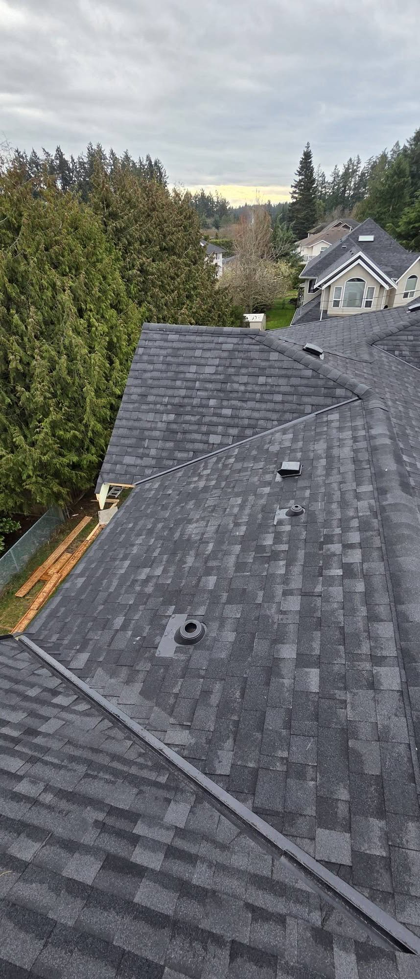 Multi-pitch residential roof with hand-detailed valley flashing