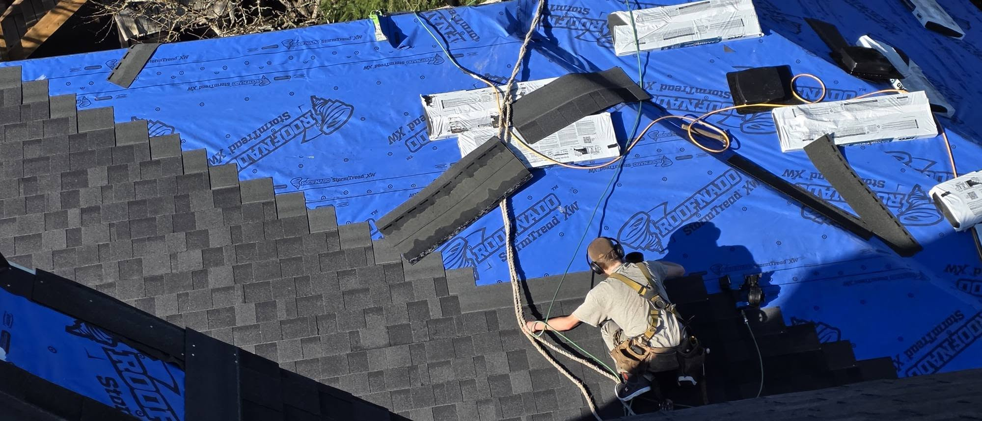 Monumental crew installing premium architectural shingles over Roofnado StormTread underlayment
